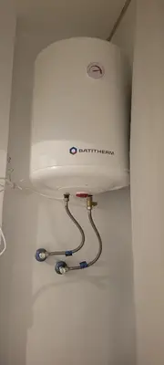 a white toilet with a tank in a bathroom at Appartement casablanca in Casablanca