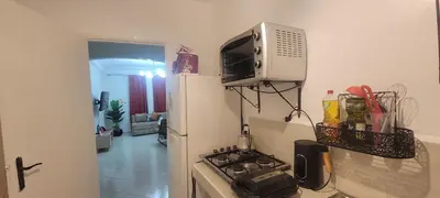 a small kitchen with a stove and a microwave at Appartement casablanca in Casablanca
