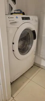 a white washing machine in a corner of a room at Appartement casablanca in Casablanca