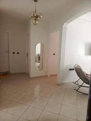 a living room with a mirror and a chair at Appartement casablanca in Casablanca