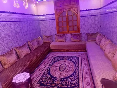 a living room with a couch and a window at appartement à al tilal in Mohammedia