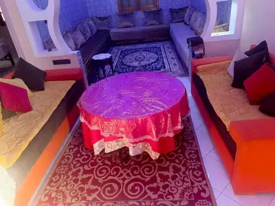 a room with a table and two couches and a red table sidx sidx sidx at appartement à al tilal in Mohammedia