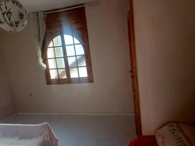 a room with a window in the corner of a room at appartement à al tilal in Mohammedia