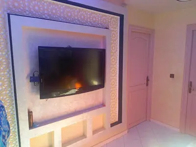 a flat screen tv hanging on a wall at appartement à al tilal in Mohammedia