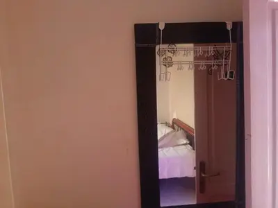 a mirror in a room with a bed at appartement à al tilal in Mohammedia