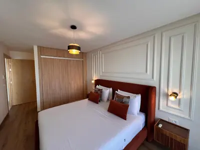 a bedroom with a bed with white sheets and pillows at Blue Carrousel in Rabat