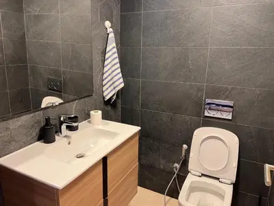 a bathroom with a white sink and a toilet at Blue Carrousel in Rabat