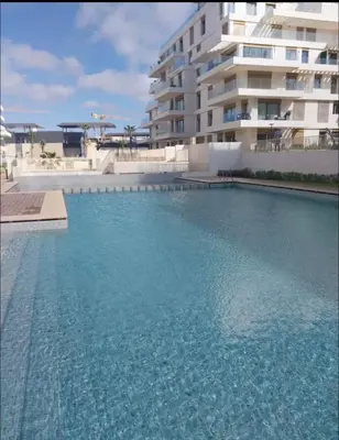 a large swimming pool in front of a building at Blue Carrousel in Rabat