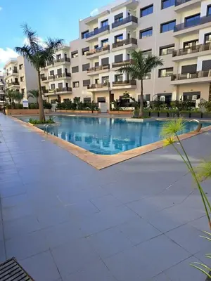 a large swimming pool in front of a building at Apartment in Manesman beach in Mohammedia