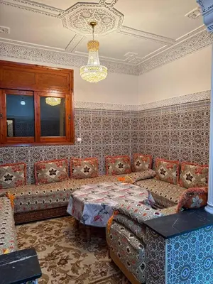 a living room with a couch and a table at Beautiful apartment with all comforts in Rabat