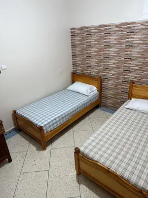 two beds sitting next to each other in a room at Beautiful apartment with all comforts in Rabat