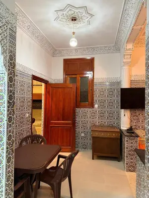 a dining room with a table and chairs at Beautiful apartment with all comforts in Rabat