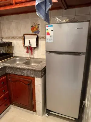 a kitchen with a refrigerator and a sink at Beautiful apartment with all comforts in Rabat