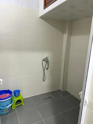 a bathroom with a shower and a bucket at Beautiful apartment with all comforts in Rabat