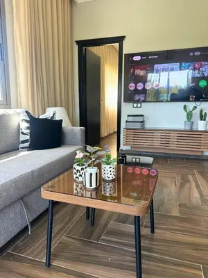a living room with a couch and a coffee table at Ferme moderne avec piscine et jardin Sejour paisible au cœur de la nature in Berrechid