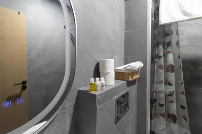 a bathroom with a shower with a mirror at Beautiful apartment with pool view in Aïn Harrouda
