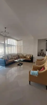 a living room with couches and chairs in a room at apparttement confort residence marina beach a mohammedia in Mohammedia