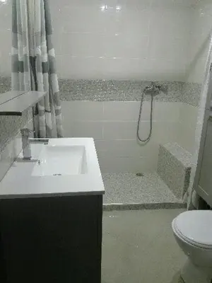 a bathroom with a sink and a shower with a toilet at apparttement confort residence marina beach a mohammedia in Mohammedia