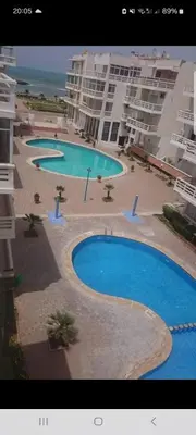 a large swimming pool in front of some buildings at apparttement confort residence marina beach a mohammedia in Mohammedia