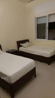 a room with two beds and a window at apparttement confort residence marina beach a mohammedia in Mohammedia