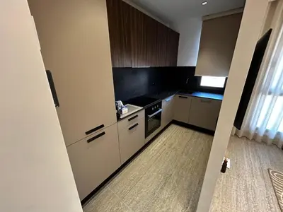 a kitchen with white cabinets and a stove at Prestige Aman in Casablanca