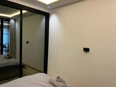 a bedroom with a wall with a mirror and a bed at Prestige Aman in Casablanca