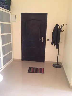 a room with a black door and a rug in front at appartement a la residence marina beach a mohammedia plage in Mohammedia