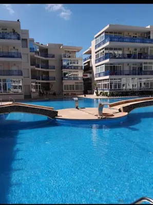 a swimming pool in front of some apartment buildings at appartement a la residence marina beach a mohammedia plage in Mohammedia