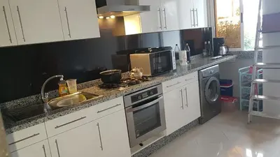 a kitchen with a sink and a stove top oven at appartement a la residence marina beach a mohammedia plage in Mohammedia