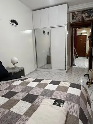 a bedroom with a bed with a checkeredkered at Super apartment Near Hassan II Mosk and Corniche in Casablanca