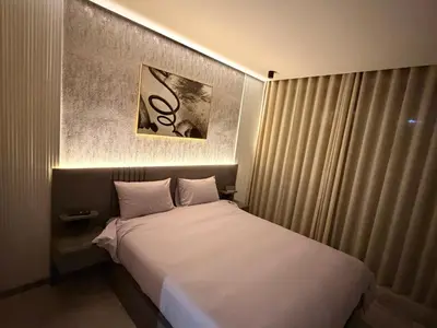 a bedroom with a bed with a large white bedsheet at Sweet Stay in Casablanca