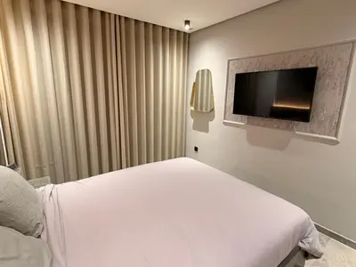 a bedroom with a bed and a flat screen tv at Sweet Stay in Casablanca