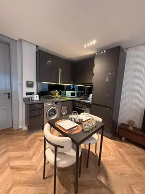 a kitchen with a table and two chairs and a kitchen at Cosy & Modern apartment with balcony, fiber WiFi & air conditioning Close To KFC & Mcdo Bd 2 Mars In The Heart Of Casablanca in Casablanca