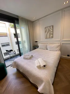 a bedroom with a large white bed with towels on it at Cosy & Modern apartment with balcony, fiber WiFi & air conditioning Close To KFC & Mcdo Bd 2 Mars In The Heart Of Casablanca in Casablanca