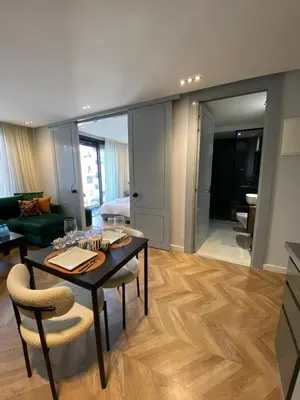 a living room with a table and chairs and a couch at Cosy & Modern apartment with balcony, fiber WiFi & air conditioning Close To KFC & Mcdo Bd 2 Mars In The Heart Of Casablanca in Casablanca