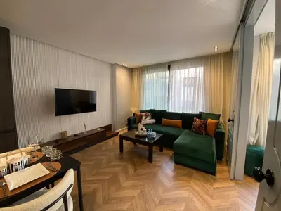 a living room with a green couch and a table at Cosy & Modern apartment with balcony, fiber WiFi & air conditioning Close To KFC & Mcdo Bd 2 Mars In The Heart Of Casablanca in Casablanca
