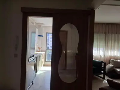 a mirror on the door of a living room at Bel appartement 2 chambres à Bourgogne in Casablanca