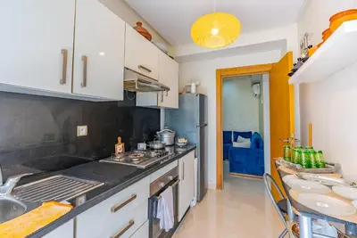 a kitchen with a sink and a counter top at Spacious luxury apartment with pool in Bouznika