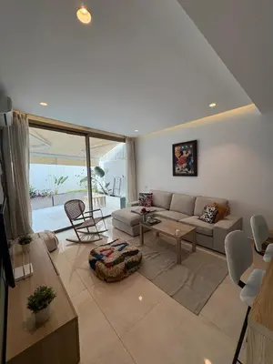 a living room with a couch and a table at Chic One Bedromm Apartment - Large Terrace - Anfa District in Casablanca
