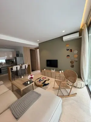 a living room with a couch and a table at Chic One Bedromm Apartment - Large Terrace - Anfa District in Casablanca