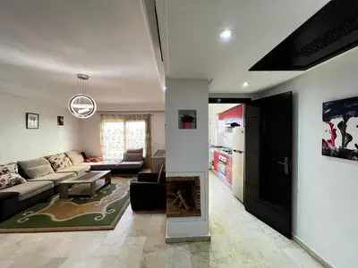 a living room with a couch and a fireplace at Maison Vacances in Casablanca