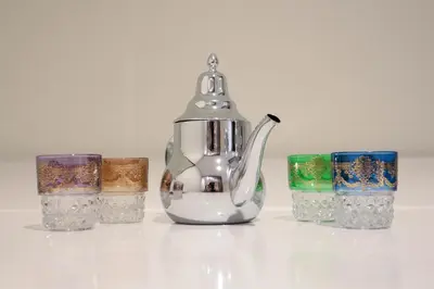 a silver tea pot sitting next to four candles at R107- Incredible 1BR Apartment with King size bed and Green Balcony in Casablanca