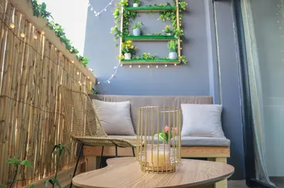 a table with a bird in a cage on a balcony at R107- Incredible 1BR Apartment with King size bed and Green Balcony in Casablanca