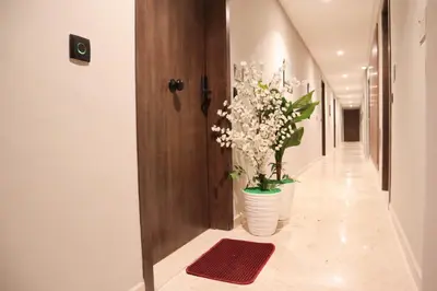 a hallway with two vases with flowers in it at R107- Incredible 1BR Apartment with King size bed and Green Balcony in Casablanca