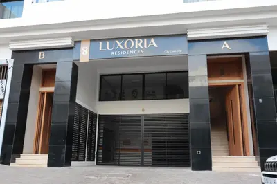 a building with a sign on the front of it at R107- Incredible 1BR Apartment with King size bed and Green Balcony in Casablanca