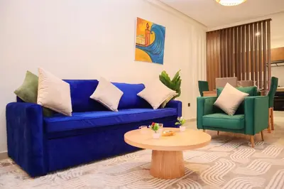 a living room with a blue couch and a table at R107- Incredible 1BR Apartment with King size bed and Green Balcony in Casablanca