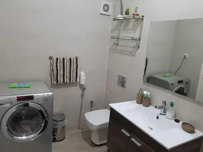 a bathroom with a washing machine and a sink at Apartment at Melissa's, sea view, Res Assabah in Rabat