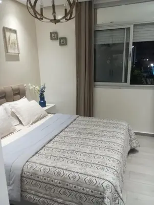 a bedroom with a large bed with a window at Apartment at Melissa's, sea view, Res Assabah in Rabat