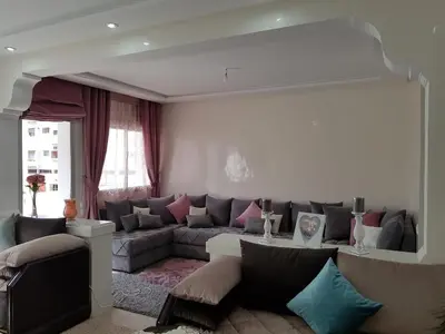 a living room with a couch and a table at Apartment at Melissa's, sea view, Res Assabah in Rabat