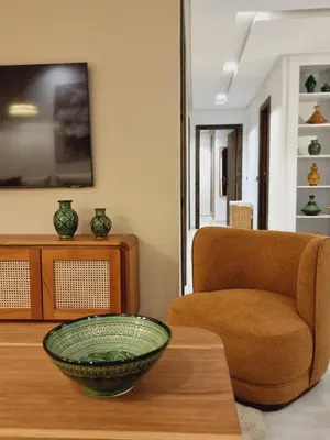 a living room with a bowl on a table and a chair at downtown rabat luxury in Rabat